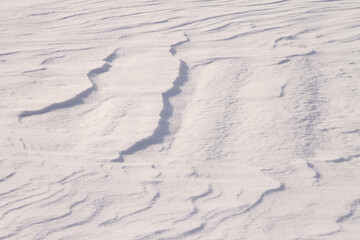 texture of fresh white snow, with a zigzag pattern from the wind