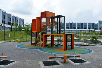 SEREMBAN, MALAYSIA -JULY 1, 2020: Selected focused on modern children outdoor playground in the public park. It was designed with a few different themes for kids to enjoy. Kids happy. 