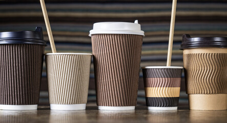 Disposable paper coffee cups in different colors and designs