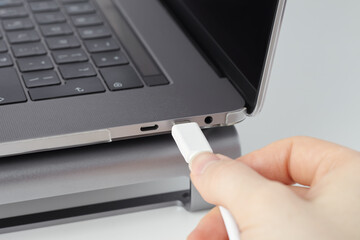 Close-up of the cable connection with the laptop usb type-c port.