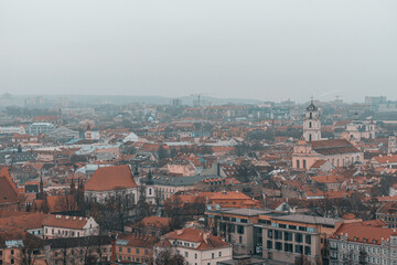 Naklejka na ściany i meble Panoramic view of the Vilnius old town during cloudy and gloomy winter day
