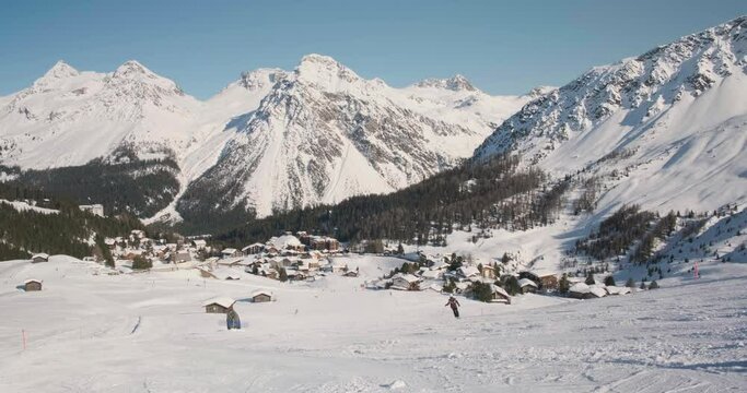 Winter sport activities in Arosa Lenzerheide ski resort, Switzerland. Ski slopes, mountain village.