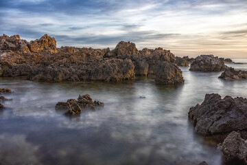 Sea Rocks illuminated by dawn light in Menorca.