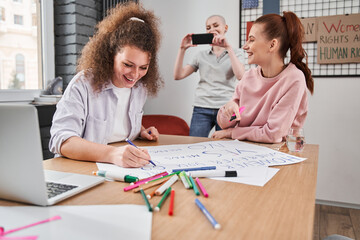 Obraz premium Girl shooting her friends at the smartphone while they preparing to the rally