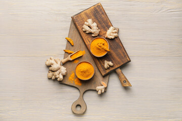 Composition with turmeric powder on wooden background