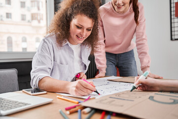 Girl holding marker and preparing to the rally about women's rights
