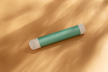 mint stick - disposable vaping device, electronic cigarette on a beige background. Flat lay, top view, minimal design with shadows of sunlight.