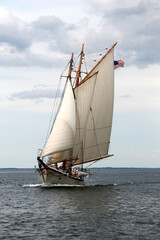 a schooner sailing on a bay