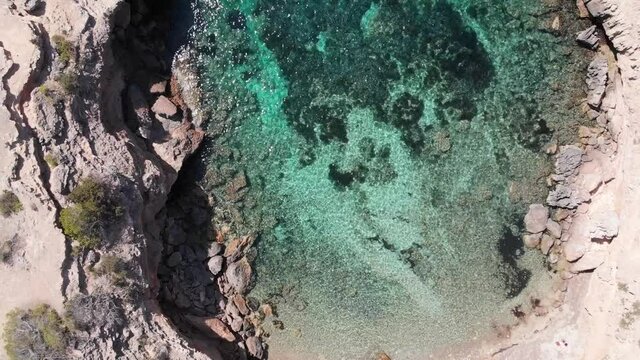Beautiful aerial shot of a turquoise beach in Ibiza Spain.