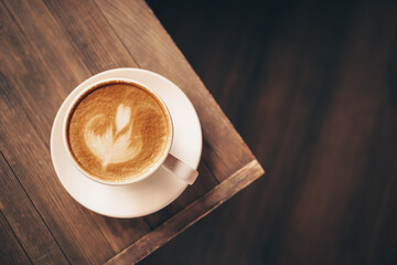 Cup of coffee with latte art on table