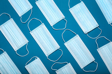 Medical masks on color background