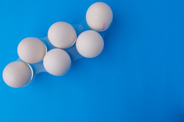Six white chicken eggs in a plastic stand. Easter card concept