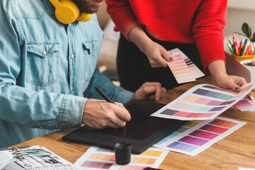 Male designer with colleague working in office