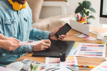 Male designer with colleague working in office