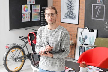 Young male designer working in office
