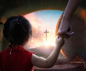 Easter concept: Child's hand holding mother's finger on blurred The cross of jesus christ...