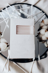 Cotton swabs in a white box and white cotton