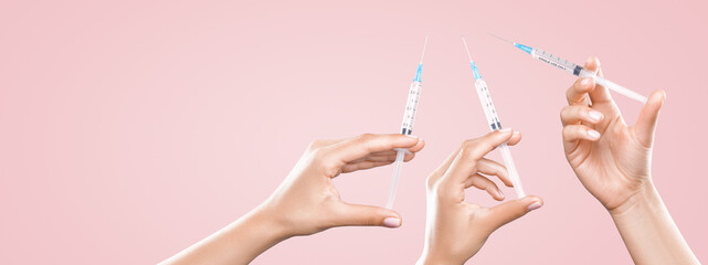 Hand holding syringe with vaccine against corona virus.