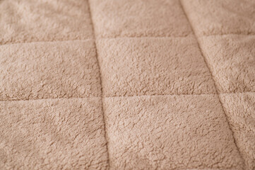 Fototapeta premium warm soft blanket spread out on the bed
