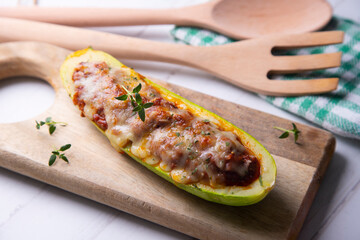 Stuffed zucchini with meat, tomato and grilled cheese 