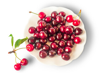 Fresh cherry in a plate, sweet eating, isolated on a white background. Top view.