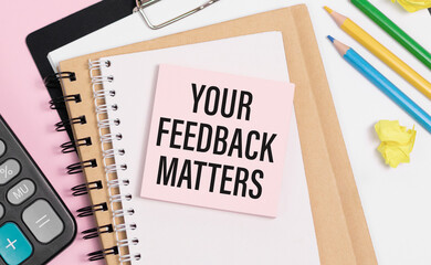 YOUR FEEDBACK MATTERS Concept. Words on notebook with smartphone, keyboard and tablet on wooden table