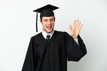 Young university Russian graduate isolated on white background saluting with hand with happy expression