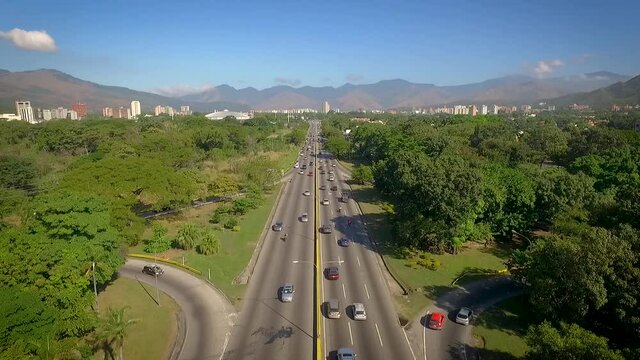 Drone view of a highway in Valencia, Carabobo, Venezuela, next to a green park