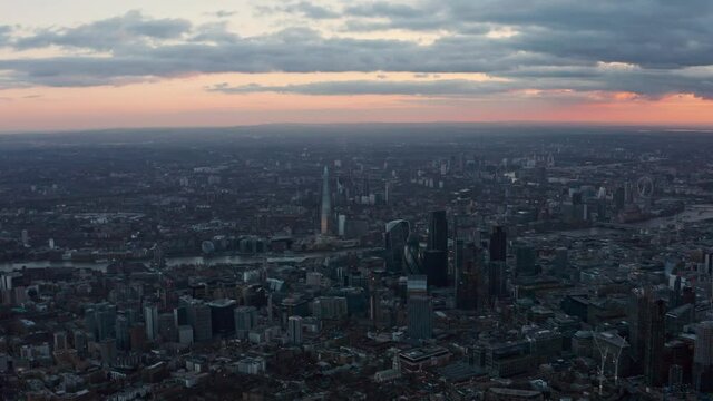 dolly forward aerial drone shot of Central City of London at dusk