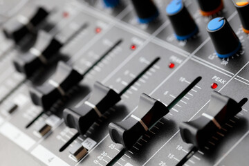 Closeup equalizer volume in the sound mixer board.