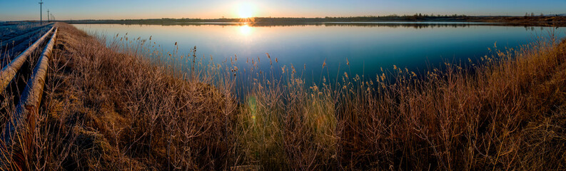 water line near the lake at sunrise and clear sky