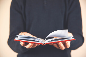 In the hands of a businessman an open notebook.