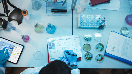 Top Down View of a Medical Research Scientist in Blue Rubber Gloves Working Behind Table in a...