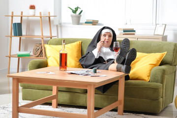 Senior nun with cigar and alcohol at home