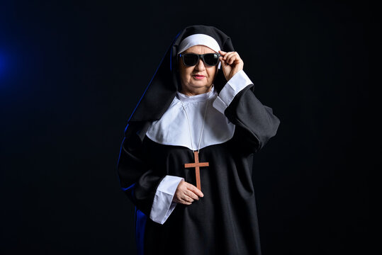 Cool senior nun on dark background