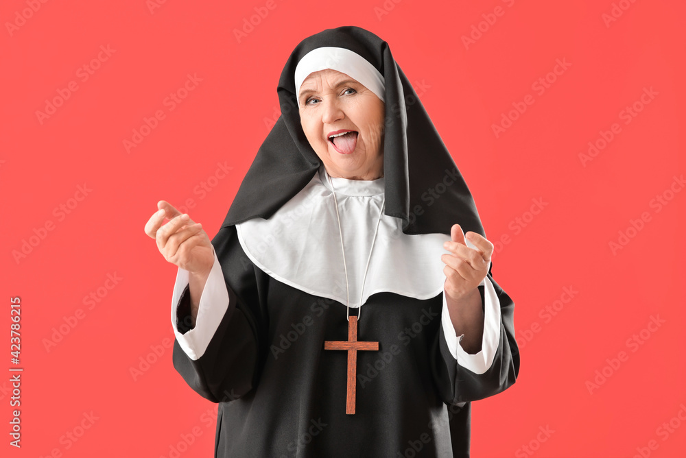 Wall mural funny senior nun on color background