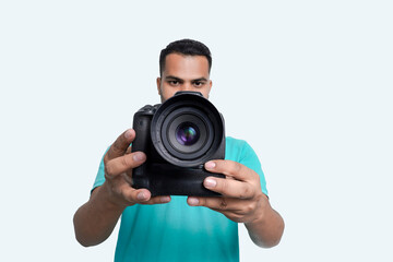 man with a professional DSLR camera, showing thumbs up, checking  photos, showing the camera, operating the camera, with a blank white plate