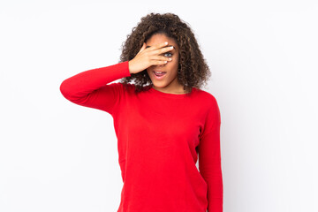 Young African American woman isolated on background covering eyes by hands and smiling