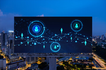 Fototapeta premium Glowing Social media icons on billboard over night panoramic city view of Kuala Lumpur, Malaysia, Asia. The concept of networking and establishing new connections between people and businesses in KL