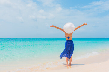 Happy free summer vacation beach bikini body woman enjoying sun carefree with open arms sunbathing...