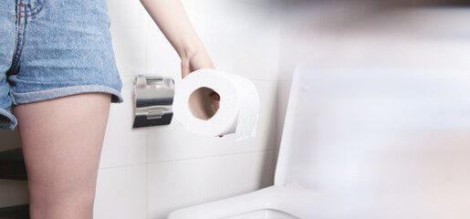 girl holding toilet papers in her hands.