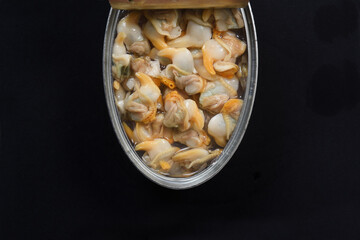 close-up of a can of cockles on black background