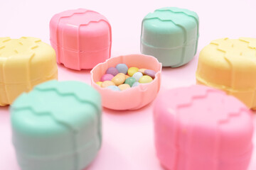 Minimalism concept of Easter candies on pink background.  Flat lay. Space for text. 