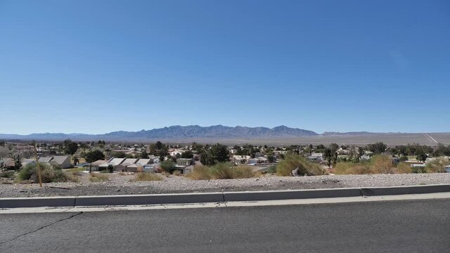 Driving on road by Laughllin, Nevada USA, desert landscape on a sunny day, right seat passenger POV