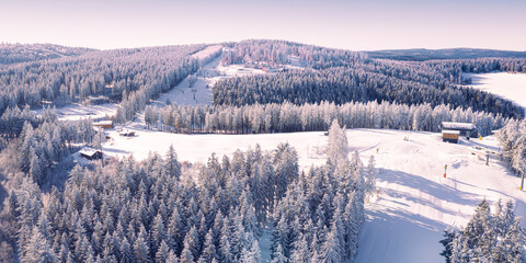 Air view on the winter sports slopes at the ski lift carousel Winterberg. Sledding slope and ski...