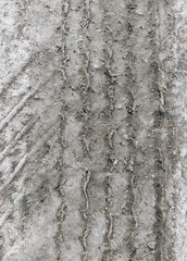 Textured traces, tread on muddy earth, sand, wet asphalt, road from a truck. Photography, concept.