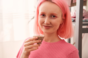 Woman looking at the camera and enjoying of the traditional japanese tea