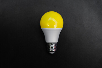 yellow light bulb on chalk background