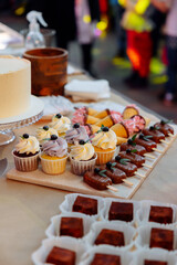 sweet table of cakes, cupcakes, ice cream on a stick and berries. Exhibition and presentation of desserts.