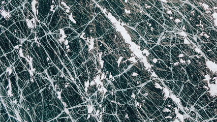 Deep Blue Cracked Ice. Top Aerial View. Frozen Texture of Baikal Lake in Russia